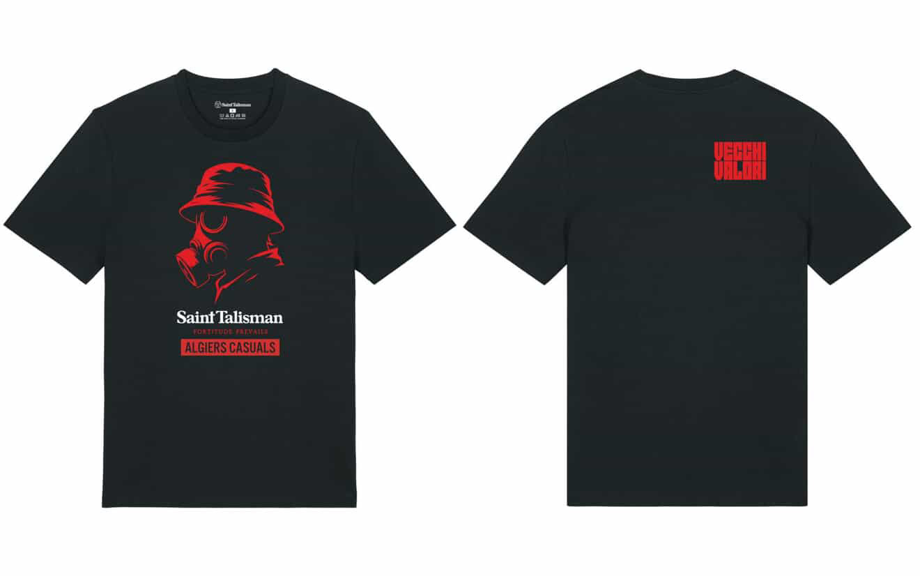 The SAINT TALISMAN x ALGIERS CASUALS black t-shirt features a red graphic of a person in a bucket hat and gas mask, Saint Talisman and Algiers Casuals text, and a small red Vigil Villain logo on the back near the neck.