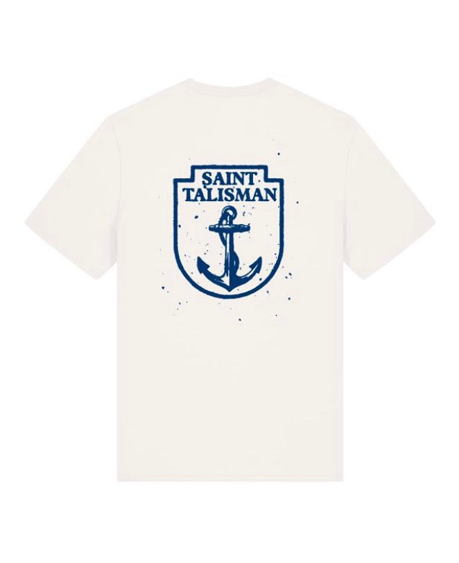 THE SHIELD TEE — ANCHOR EDITION in Vintage White showcases a blue anchor and rope emblem with SAINT TALISMAN above, all within a shield outline on the back. Bold blue splatter accents complete the distinctive look.